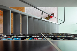 Illustration for article titled This Dream House Was Entirely Built Around a Giant Three-Story-High Bookshelf